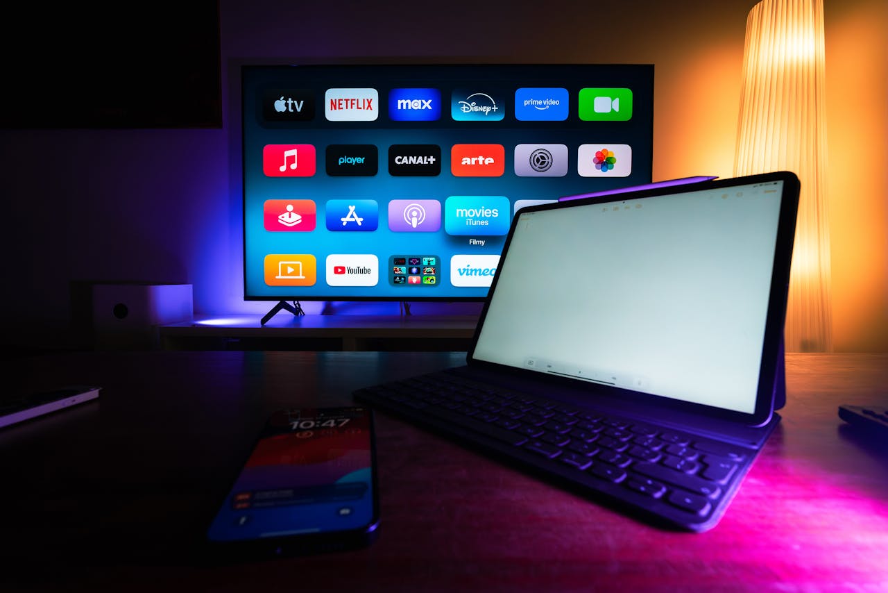 team-02 A modern home setup with a smart TV and tablet displaying various streaming apps, highlighting the digital lifestyle.